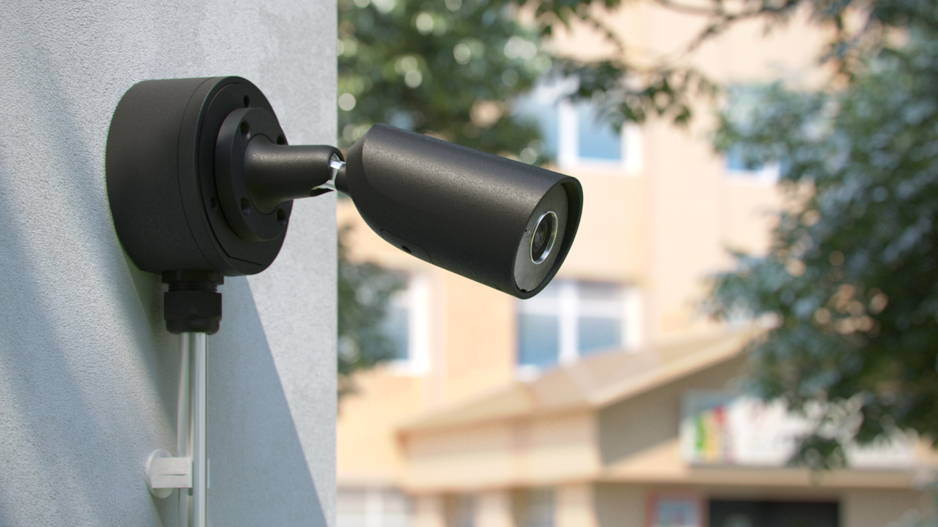 Überwachungskamera Eine Überwachungskamera montiert an einer Wand, mit einem Gebäude im Hintergrund.